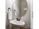 Charming powder room features a pedestal sink, oval mirror, and bronze fixtures at 4224 Park South Station Blvd, Charlotte, NC 28210