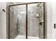 A frameless shower with gray tile, mosaic accents, and a built-in seat at 4224 Park South Station Blvd, Charlotte, NC 28210