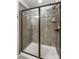 A frameless shower with gray tile, mosaic accents, and a shower head at 4224 Park South Station Blvd, Charlotte, NC 28210