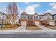 Charming two-story townhome featuring a brick facade, attached garage, and well-maintained landscaping at 4224 Park South Station Blvd, Charlotte, NC 28210