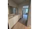 Bright bathroom featuring a double sink vanity with modern countertops and wood-look flooring, offering style and functionality at 44389 Us 52 N Hwy, Richfield, NC 28137