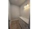 Powder room featuring a marble vanity top, white cabinets, and modern lighting at 44389 Us 52 N Hwy, Richfield, NC 28137