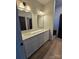 Modern bathroom featuring a double sink vanity, custom light fixtures, and tile flooring, providing a stylish and functional space at 44389 Us 52 N Hwy, Richfield, NC 28137