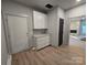 Hallway featuring a custom kitchen, a modern pantry and wood look flooring, providing a stylish and functional living space at 44389 Us 52 N Hwy, Richfield, NC 28137