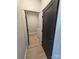Hallway leading to powder room with a contrasting black door and wood flooring at 44389 Us 52 N Hwy, Richfield, NC 28137