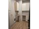 Functional laundry room with wooden floors, white cabinets, ample countertop space, and modern fixtures at 44389 Us 52 N Hwy, Richfield, NC 28137