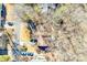 An aerial view of a house with a brown roof, set among trees, showcasing the property's location and landscaping at 5011 Tara Tea Dr, Tega Cay, SC 29708