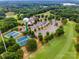 Aerial view showcasing the community clubhouse, pool, tennis courts, and golf course near Lake Wylie at 5011 Tara Tea Dr, Tega Cay, SC 29708