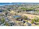 Aerial view of 5011 Tara Tea Dr, nestled in a wooded neighborhood with nearby golf course and water views at 5011 Tara Tea Dr, Tega Cay, SC 29708