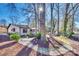 Spacious backyard with mature trees, landscaped areas, and a charming patio, perfect for outdoor enjoyment and relaxation at 5011 Tara Tea Dr, Tega Cay, SC 29708