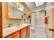 Well-lit bathroom featuring a vanity with marble countertop, a medicine cabinet, and a shower-tub combination at 5011 Tara Tea Dr, Tega Cay, SC 29708