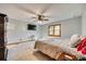 Neutral bedroom with ceiling fan, a window, carpet flooring, and wall-mounted television at 5011 Tara Tea Dr, Tega Cay, SC 29708
