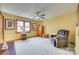 Bedroom with ample space, natural light, carpet flooring, a ceiling fan, and comfortable seating at 5011 Tara Tea Dr, Tega Cay, SC 29708