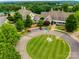 Aerial view of the clubhouse featuring well-manicured grounds, parking, and easy access at 5011 Tara Tea Dr, Tega Cay, SC 29708