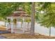 Charming white gazebo next to a serene lake with views of the water and surrounding nature at 5011 Tara Tea Dr, Tega Cay, SC 29708