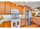Updated kitchen featuring stainless steel appliances, granite countertops, white tile backsplash, and wood cabinets at 5011 Tara Tea Dr, Tega Cay, SC 29708