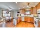 Warm kitchen featuring wood cabinets, stainless steel trash can, granite countertops, and a cozy breakfast nook at 5011 Tara Tea Dr, Tega Cay, SC 29708