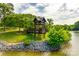 Picturesque lake view with gazebo and lush green landscaping on a sunny day at 5011 Tara Tea Dr, Tega Cay, SC 29708