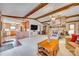 Open layout of the living room showing the kitchen area, stone fireplace, and exposed beams at 5011 Tara Tea Dr, Tega Cay, SC 29708