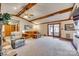 Comfortable living room showcasing exposed beams, a fireplace, and sliding doors leading to an outdoor area at 5011 Tara Tea Dr, Tega Cay, SC 29708