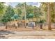 Community playground with slides, climbing structures, and benches surrounded by trees at 5011 Tara Tea Dr, Tega Cay, SC 29708