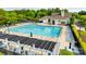 Aerial view of a pool with lounge chairs, shaded pergola, and the community clubhouse in the background at 5011 Tara Tea Dr, Tega Cay, SC 29708