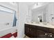 Well-lit bathroom with double sinks, a large mirror, and a shower/tub combination at 5041 Wakehurst St, Kannapolis, NC 28081
