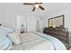 Bedroom boasts a ceiling fan, large dresser with a mirror, and a view to the en suite bathroom at 5041 Wakehurst St, Kannapolis, NC 28081