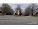 Community entrance with a stone sign, beautiful landscaping, and a welcoming atmosphere at 5041 Wakehurst St, Kannapolis, NC 28081