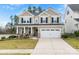 Charming two-story home with a manicured lawn and a two-car garage, perfect for suburban living at 5041 Wakehurst St, Kannapolis, NC 28081