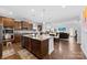 Modern kitchen featuring a center island with a sink, and an open layout connecting to the dining area at 5041 Wakehurst St, Kannapolis, NC 28081