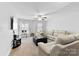 Comfortable living room features plush seating, a ceiling fan, and a window with natural light at 5041 Wakehurst St, Kannapolis, NC 28081