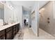 Main bathroom featuring double sinks, tile shower, and plenty of counter space at 5041 Wakehurst St, Kannapolis, NC 28081