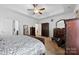 Spacious main bedroom featuring tray ceiling, ceiling fan, and walk-in closet at 5041 Wakehurst St, Kannapolis, NC 28081