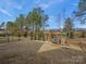 This beautiful fenced backyard features well maintained lawn, a playset and lush landscaping at 518 Palmarosa St, Fort Mill, SC 29715