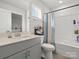 Bright bathroom featuring a single sink with storage and a shower-tub combo with colorful curtain at 518 Palmarosa St, Fort Mill, SC 29715