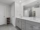 Modern bathroom featuring double vanities, a large mirror, and gray cabinets for a contemporary look at 518 Palmarosa St, Fort Mill, SC 29715