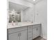 Bright bathroom featuring double sinks, gray cabinets, and a large mirror for a clean, modern look at 518 Palmarosa St, Fort Mill, SC 29715