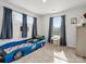 Fun bedroom featuring a car-shaped bed, neutral walls, carpeted floor, and natural light at 518 Palmarosa St, Fort Mill, SC 29715