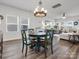 Charming dining area featuring wood floors, a round dining table, and ample natural light at 518 Palmarosa St, Fort Mill, SC 29715