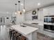 Modern kitchen features an island with seating, stainless steel appliances, and pendant lighting at 518 Palmarosa St, Fort Mill, SC 29715