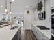Well-lit kitchen with gray cabinets, stainless appliances, kitchen island with bar stools, and hardwood flooring at 518 Palmarosa St, Fort Mill, SC 29715