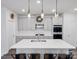 Modern kitchen features an island with seating, stainless steel appliances, and pendant lighting at 518 Palmarosa St, Fort Mill, SC 29715