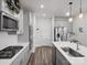 Bright kitchen featuring gray cabinets, stainless appliances, and hardwood flooring at 518 Palmarosa St, Fort Mill, SC 29715
