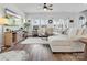 Bright living room featuring a large sectional sofa and ample windows with natural light at 518 Palmarosa St, Fort Mill, SC 29715