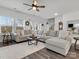 Spacious living room with a large sectional sofa, neutral tones, and plenty of natural light at 518 Palmarosa St, Fort Mill, SC 29715