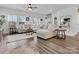 Spacious living room with large sectional couch, lots of natural light, and hardwood flooring at 518 Palmarosa St, Fort Mill, SC 29715