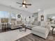 Spacious living room with a large sectional sofa, neutral tones, and plenty of natural light at 518 Palmarosa St, Fort Mill, SC 29715