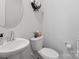 Clean and bright powder room with a pedestal sink and modern fixtures at 518 Palmarosa St, Fort Mill, SC 29715