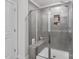 Sleek, tiled shower with glass door and built-in bench offers a luxurious and modern bathing experience at 518 Palmarosa St, Fort Mill, SC 29715